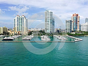 Sleek City Skyscrapers bordering Beautiful Ocean Marina of Yachts and Boats