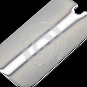 A sleek, metallic, rectangular object with smooth, rounded