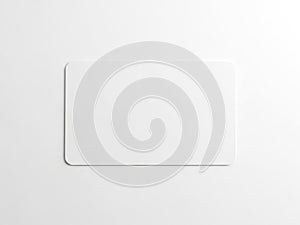 A sleek, minimalist white rectangular object with rounded edges on a white background
