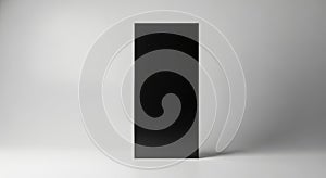 Sleek modern black rectangular object on a light grey surface