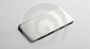 A sleek, rectangular, metallic object lies on a white surface. The object has rounded edges and a