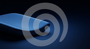 A sleek, rectangular object with smooth, rounded edges is illuminated by a soft blue