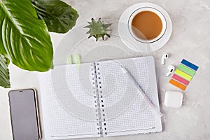 Sleek and Simple - Office Essentials Flat Lay with Pen and Notepad with a cup of coffee, sticky stickers, headphones