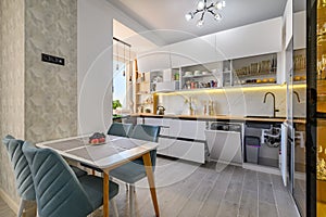 A sleek white kitchen with drawers pulled out to their full length