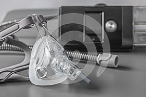 Sleep apnea CPAP mask on the grey table