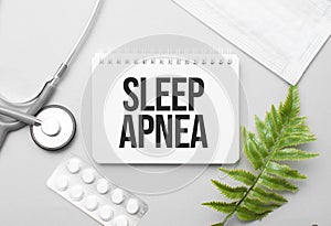 sleep apnea word on notebook,stethoscope and green plant