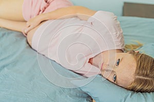 Sleep-deprived pregnant woman struggles with insomnia, navigating the challenges of restlessness during pregnancy photo