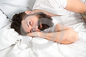 Sleep disorders concept. What a long night. Man bearded hipster having problem with sleep. Guy lying in bed try to relax