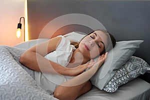 Sleep health. Young beautiful woman sleeps in the bed. Girl with regulated circadian cycle sleeps blissfully