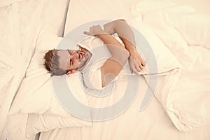 Sleep problems can lead to headaches in morning. Migraine headaches. Handsome man relaxing in bed. Snoring can increase