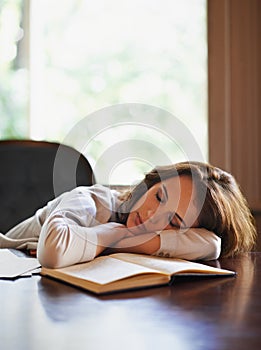 Sleep, remote worker and tired woman with books, fatigue or snooze while writing in home office. Freelance, burnout or
