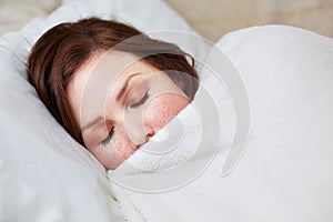 Sleep, rest and woman in bed, peaceful and enjoying a calm nap in her quiet home. Eyes closed, dreaming and female