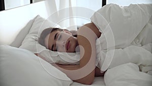 Sleep. Woman Sleeping In Bed With White Bedding At Light Bedroom