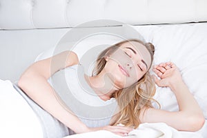 Sleep. Young Woman sleeping in bed, portrait of beautiful female resting on comfortable bed with pillows in white bedding