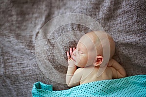Sleeper newborn baby, gray background