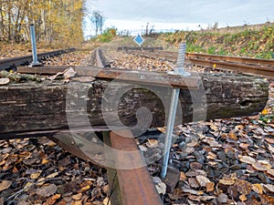 The sleeper screwed acrossing railway. Railroad with vanishing point