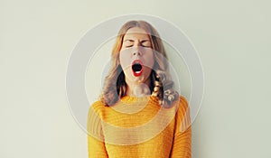 Sleepiness. Young tired woman yawns opens her mouth wide