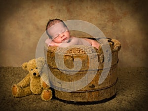 Sleeping baby in antique bucket