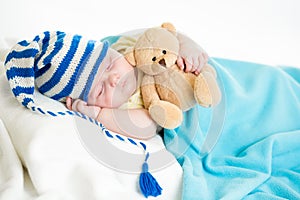 Sleeping baby boy with toy