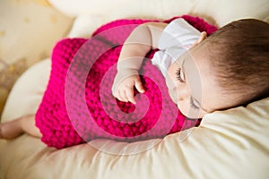 Sleeping baby covered with knitted blanket