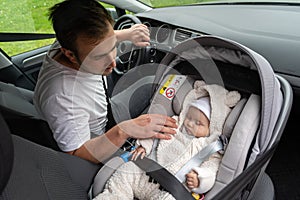 Sleeping baby girl in baby car seat