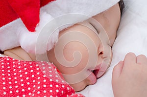 Sleeping baby girl Santa Claus