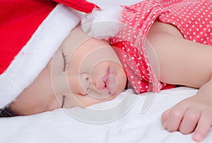 Sleeping baby girl Santa Claus