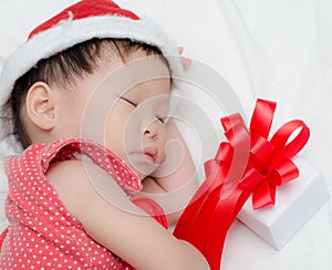 Sleeping baby girl Santa Claus