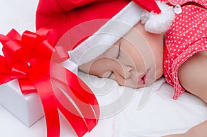 Sleeping baby girl Santa Claus