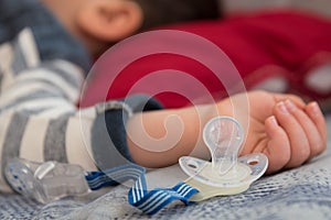 Sleeping baby with pacifier - closeup