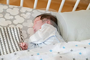 Sleeping baby. Peaceful baby lying on a bed while sleeping in a bright room