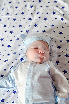 Sleeping baby. Peaceful baby lying on a bed while sleeping in a bright room