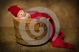 Sleeping baby in vintage bucket