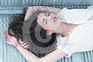 Sleeping beauty. Woman with long hair sleep on bench. Arabian woman relax with closed eyes, pure look. Total relaxation