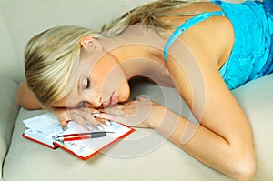 Sleeping Blonde woman with datebook