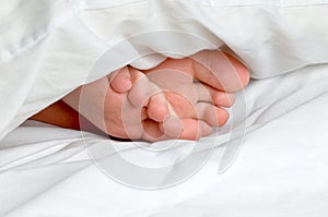 A sleeping child's feet in bedding