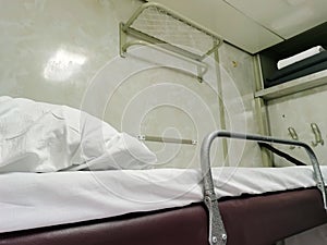 Sleeping compartment of a passenger train from the inside. Upper berth