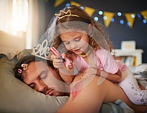 Sleeping, dad and girl drawing for fun, game and April Fools joke on face, body and paint with pink makeup. Father