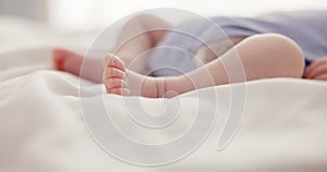 Sleeping, dreaming and feet of baby on bed for child care, resting and relax in nursery. Adorable, cute and closeup of