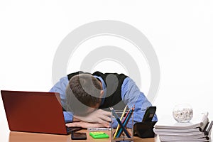 Sleeping employee in the office at the table put his head on his hands
