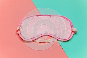 Sleeping mask on pink and blue background