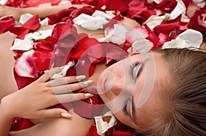 Sleeping girl in rose petal