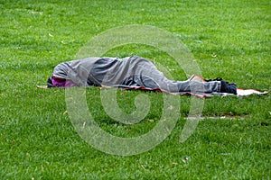 Sleeping homeless person in blanket