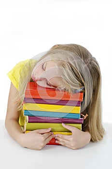 Sleeping while learning - tired little girl sleeping on desk.