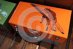 A sleeping lioness is drawn on a metal suitcase in a store (France)