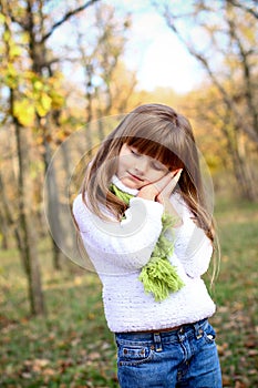 Sleeping little girl in the autumn forest