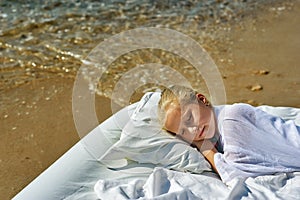 Sleeping little girl on the seashore