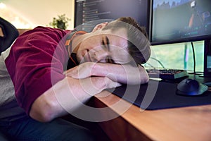Sleeping Man Gaming At Home Sitting At Desk With Multiple Monitors