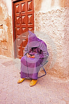 Sleeping maroccan man in the streets of Marrakech