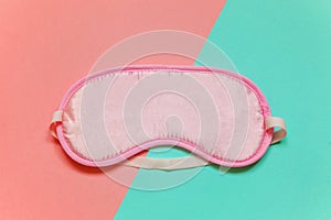 Sleeping mask on pink and blue background